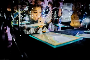 Woman and girl looking in glass case.